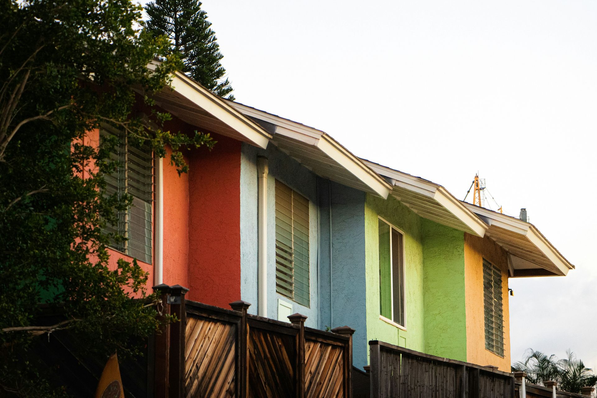 a row of multicolored houses on a street