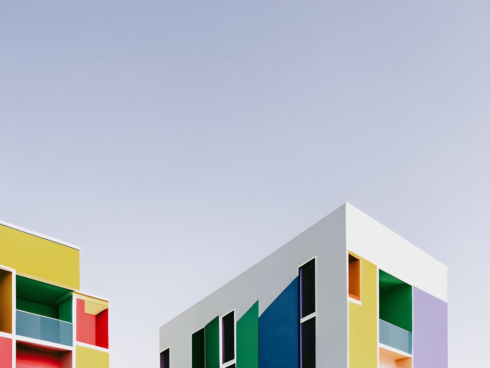 Vibrant modern architecture featuring multi-colored apartment facades under a clear blue sky.